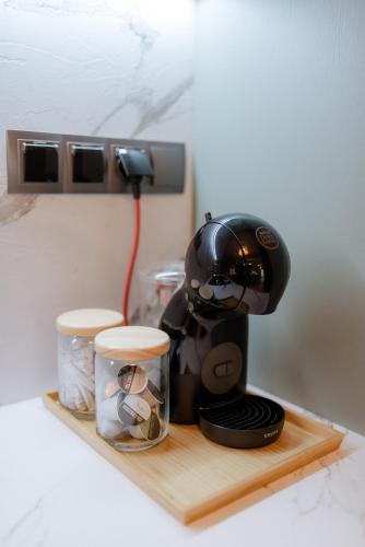 a coffee maker is sitting on a wooden shelf at Urban Jasmine in Thessaloniki