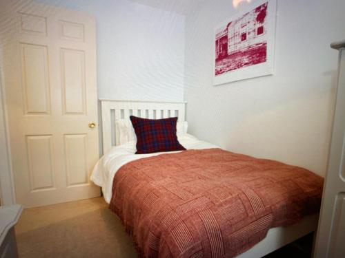 a bedroom with a bed with a pillow on it at Secret View Cottage in Terrington, York in York