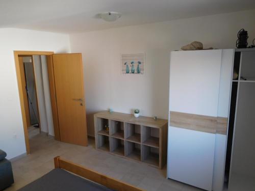 a living room with a refrigerator and a shelf at Vila Maria Nin in Nin