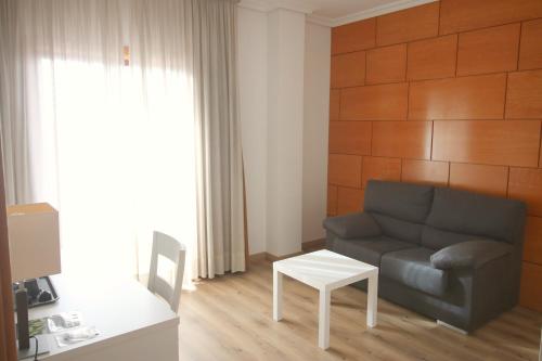a living room with a couch and a table at Hotel Alfonso I in Tui