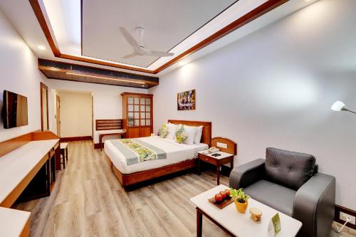 a hotel room with a bed and a couch at E Square The Fern, Pune in Pune
