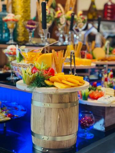a table with a bunch of fruits and vegetables on a counter at Dedeman Erbil Hotel City Center in Erbil