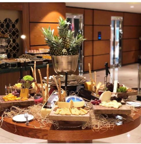 a buffet of food on a table in a restaurant at Dedeman Erbil Hotel City Center in Erbil