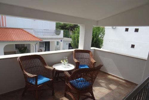 a balcony with a table and chairs on a balcony at Vila Maria Nin in Nin