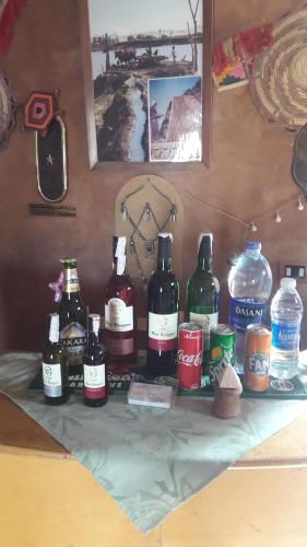 a table topped with bottles and bottles of wine at Eskaleh Eco-Lodge in Abu Simbel