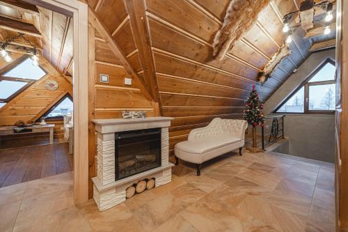 a living room with a fireplace in a log cabin at TatrApart in Zakopane