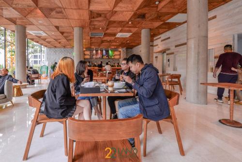 a group of people sitting at a table in a restaurant at 22Land Hotel & Residence in Hanoi