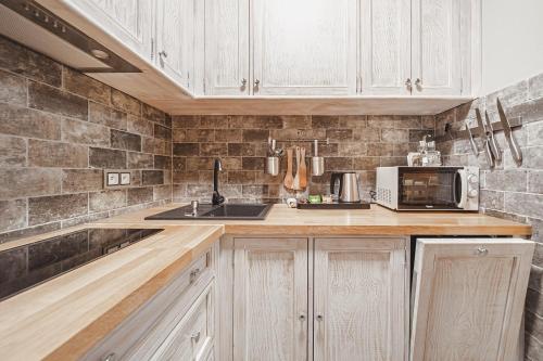 a kitchen with a sink and a microwave at TatrApart in Zakopane