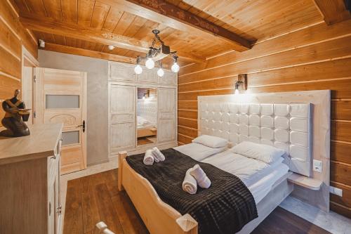 a bedroom with a bed with two shoes on it at TatrApart in Zakopane
