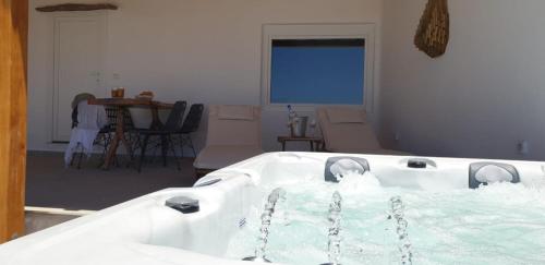 a bath tub filled with water in a living room at Blue Serenity Villa in Fanari