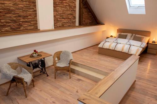 a room with a bed and a table and chairs at Chalupa Morava in Uherčice