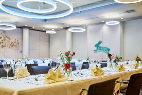 a row of tables in a banquet hall with chairs at Ringhotel Gasthof Hasen in Herrenberg