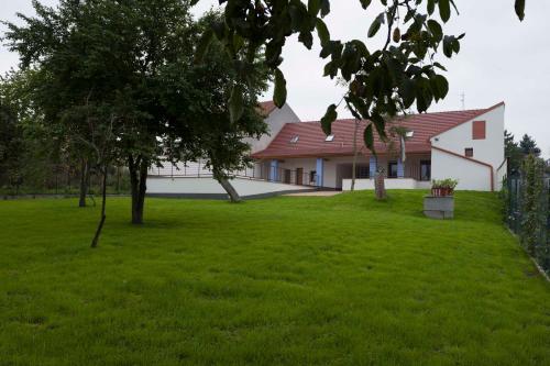 a house with a green lawn in front of it at Chalupa Morava in Uherčice