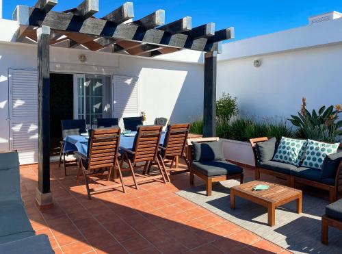 a patio with a table and chairs on a patio at Cabanas de Tavira in Cabanas de Tavira