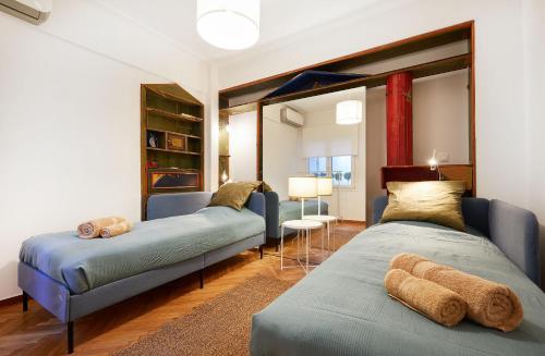a living room with two beds and a couch at Chloe Boutique Apartments Nikis in Athens
