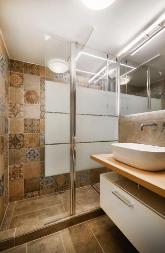 a bathroom with a sink and a shower at Chloe Boutique Apartments Nikis in Athens