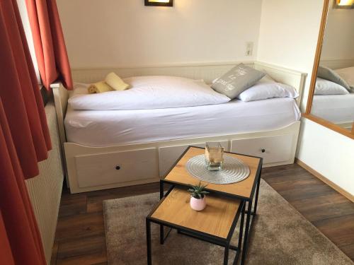 a small room with a bed and a table at Magali's, Bed & Breakfast - inclusive Summer Card in Zell am See