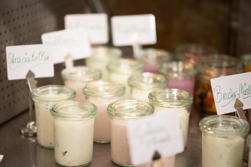 a group of jars of candles on a table at Hotel Schlair in Kremsmünster