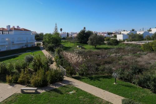 a view of a park with grass and bushes at Cabanas de Tavira in Cabanas de Tavira