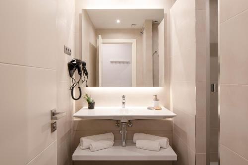a bathroom with a sink and a mirror at Aspasios Market Balconies Apartments in Barcelona