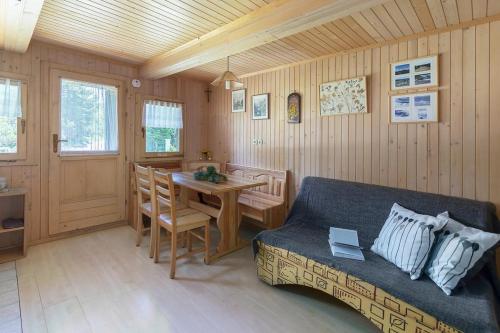 a living room with a couch and a table at Chalet Encijan - Velika planina in Stahovica