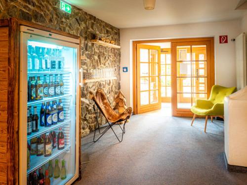 a room with a refrigerator full of soda bottles at Mäsers Allgäuherz in Wiggensbach