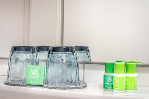 a shelf with two glasses and bottles on it at Mäsers Allgäuherz in Wiggensbach