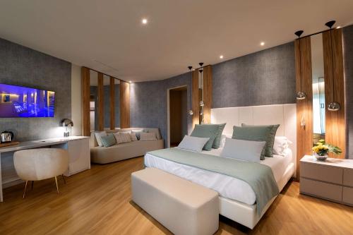 a bedroom with a bed and a living room at San Severino Park Hotel & SPA, BW Signature Collection in Mercato San Severino