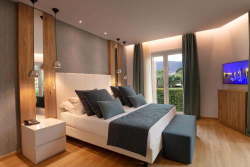 a bedroom with a large bed and a tv at San Severino Park Hotel & SPA, BW Signature Collection in Mercato San Severino