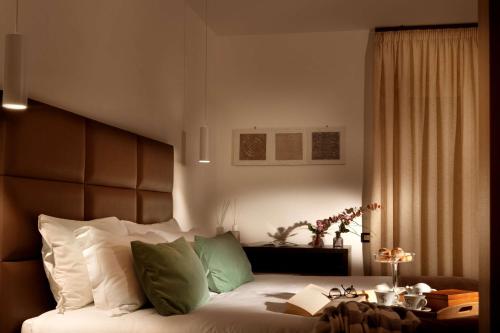 a bedroom with a large bed and a table at San Severino Park Hotel & SPA, BW Signature Collection in Mercato San Severino