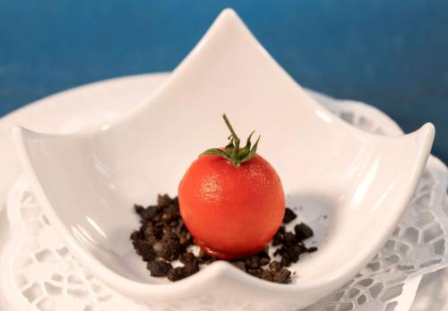 a tomato in a white bowl on a plate at San Severino Park Hotel & SPA, BW Signature Collection in Mercato San Severino
