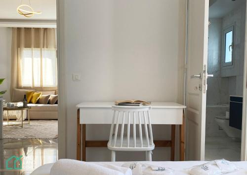 a white kitchen with a white counter in a room at Le Safran - apt renove, spacieux et central a Marsa in Carthage