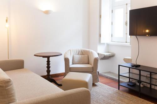 a living room with a couch and a chair and a table at VIVA Casa da Vila River & Sea in Porto-Family & Friends in Porto
