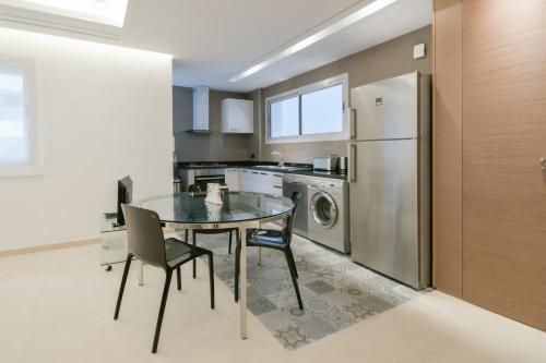 a kitchen with a glass table and a refrigerator at Luxury one bedroom apartment - Best location in Rabat