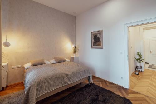 a bedroom with a bed in a white room at Apartmány Marienhof in Znojmo