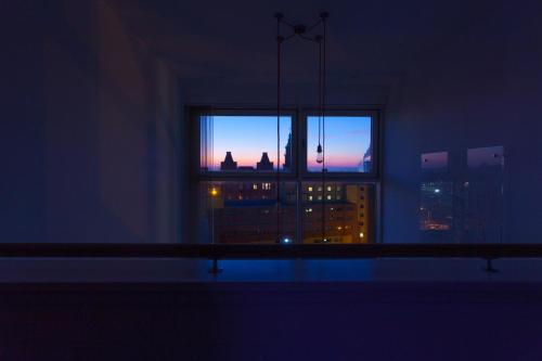 a room with a window with a view of a city at CITY CENTRE APARTMENT with Free Secure Underground Parking in Glasgow