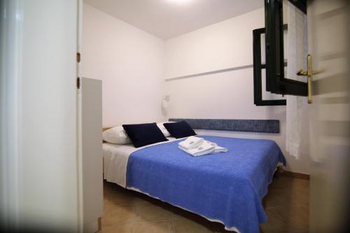 a bedroom with a bed with a blue blanket at Apartment Ljubica Tisno in Tisno