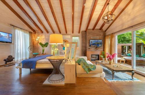a bedroom with a bed and a couch and a table at Villa Lukka in Cıralı