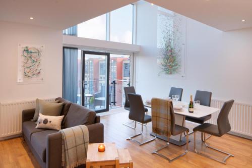 a living room with a couch and a table at CITY CENTRE APARTMENT with Free Secure Underground Parking in Glasgow