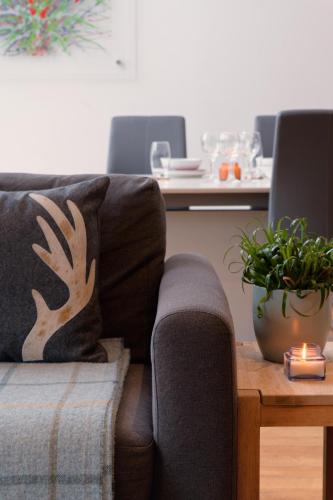 a living room with a couch and a table at CITY CENTRE APARTMENT with Free Secure Underground Parking in Glasgow