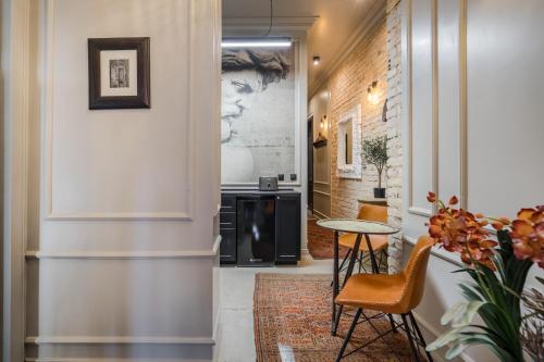 a hallway with a table and chairs at BpR Violet Noir Apartment with A/C in Budapest
