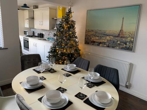 a kitchen with a table and a christmas tree at The Kensingston - Quaint Victorian Home With Free Parking in York