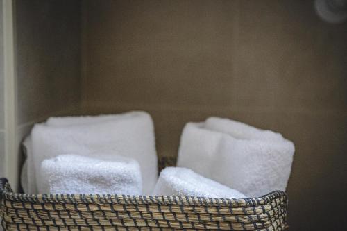 a basket filled with white towels in a room at Apartamentos Barbara 3 in Alicante