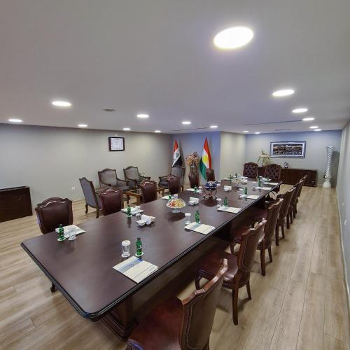 a large conference room with a long table and chairs at Dedeman Erbil Hotel City Center in Erbil