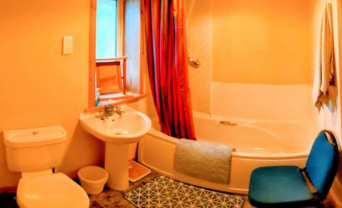 a bathroom with a sink and a toilet and a shower at Hamnavoe John o Groats Hostel in John O Groats