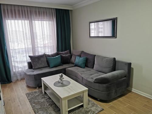 a living room with a couch and a coffee table at Apartman DalMe in Novi Pazar