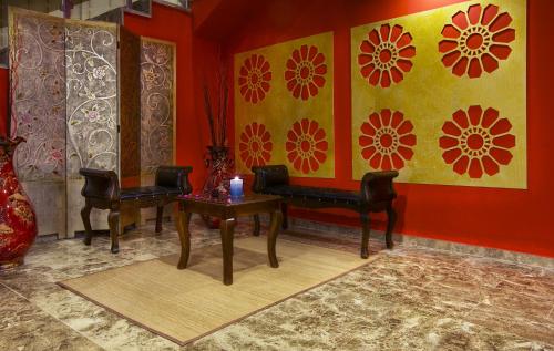 a room with a piano and two chairs and a table at Dedeman Erbil Hotel City Center in Erbil