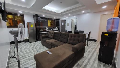 a living room with a couch and a camera at Finteo Skylands Premium in Baguio