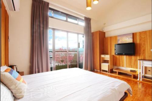 TV a/nebo společenská místnost v ubytování Sanyi Dream Garden B&B