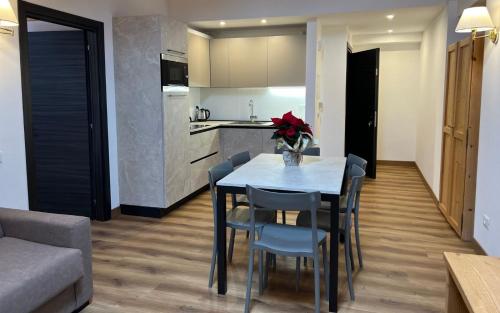 a kitchen and dining room with a table and chairs at Antico Albergo Stella d'Italia in Folgaria